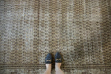 Distressed Mir Serbend carpet with allover ivory and charcoal boteh pattern showing textured wear.