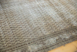 Distressed vintage Mir Serbend rug corner, featuring exposed foundation and a faded charcoal border.
