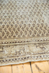 Vintage Distressed Mir Serbend carpet showing allover ivory boteh pattern, wear, and traditional border detail.
