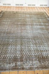 Vintage Distressed Mir Serbend rug displaying worn antique ivory boteh design and patterned border.