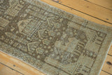 Detailed view of distressed Sivas rug runner with beige, bronze pictorial motifs and visible wear.