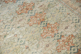 Distressed ivory field with terracotta and muted blue repeating panels on a vintage Sivas rug.