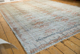 Distressed vintage Sivas carpet corner, featuring Safavid dragon border in terracotta and ivory.