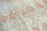 Textured vintage distressed Sivas rug showing visible wear, ivory, terracotta, and blue hues.