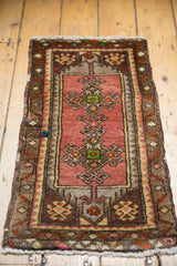 Original side selvages of vintage Oushak rug, dusty blush, chocolate brown, and geometric patterns.