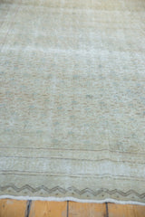 Distressed vintage Kayseri rug texture, revealing faded floral patterns and zig-zag border.