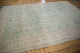 Distressed texture of vintage Sparta carpet with pale seafoam green floral vinery.