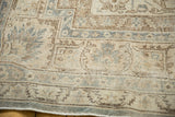 Distressed vintage Sivas rug border with faded blue and bronze curvilinear patterns.