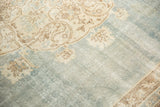 Abrashed pale blue field with faded ivory arabesques and distressed texture on vintage Sivas.