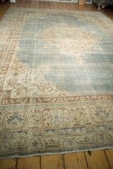Distressed Sivas carpet, traditional ivory patterned border and abrashed pale blue field.