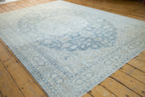 Distressed Oushak carpet detail with pale teal Rococo leaves and sprawling ivory vinery.