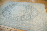 Textured detail of vintage Oushak rug featuring pale teal Rococo leaves and floral vinery.