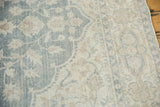 Distressed Oushak rug, pale teal floral vinery, even wear with faint foundation.