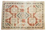 Distressed vintage Sivas carpet showcases a teal medallion, red floral motifs, and textural abrash.
