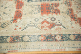 Teal, red curvilinear floral motifs and abrash on a vintage distressed Sivas carpet section.