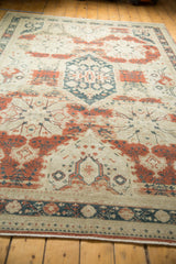 Distressed red and teal curvilinear patterns with geometric border on vintage Sivas carpet.