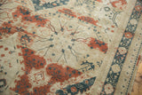 Distressed Sivas carpet: muted red curvilinear florals, teal geometric mapping, and abrash on beige.