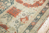 Distressed Sivas carpet showing heavy abrash, red, teal, and ivory patterns, with faint foundation.