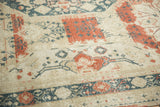 Distressed Sivas carpet detail with worn red, teal, ivory patterns and heavy abrash.