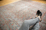Distressed Mahal carpet texture featuring muted sky blue and blush red Herati patterns.