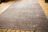 Distressed vintage Mahal carpet edge, with faded sky blue and blush red motifs.