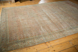 Distressed vintage Mir Serbend carpet, showing faded allover boteh and traditional vinery border.