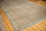 Distressed texture of Mir Serbend rug showcasing vinery and geometric floral border.