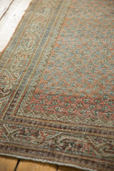 Intricate Mir boteh design and Serbend border in distressed terra cotta, ivory, and silver tones.