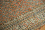 Distressed Mir Serbend carpet detail: chestnut terra cotta boteh and intricate geometric border.