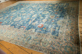 Distressed blue Tabriz carpet with sprawling vinery, palmettes, and an intricate floral border.