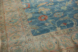 Distressed sky blue Tabriz carpet field, wine red florals, ornate pale blush border.