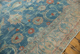 Distressed blue field with sprawling vinery, red palmettes, and worn beige border.
