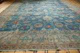 Distressed Tabriz carpet corner with sky blue field, red floral vinery, and ornate beige border.