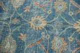 Distressed vintage Tabriz rug with sky blue field, beige palmettes, and areas of foundation showing.