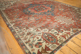 Fragmented antique Serapi carpet with secured edge, featuring madder red, blue, ivory motifs and wear.