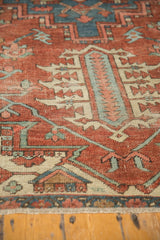 Antique Serapi carpet detail with madder root red, sky blue, and ivory geometric patterns.