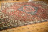 Antique Serapi carpet segment: madder red field, sky blue geometric pattern, mostly even wear.