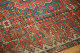 Antique Serapi carpet section with madder root red field, bold geometric sky blue patterns.