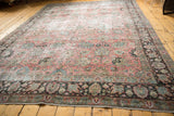 Vintage Tabriz rug showcasing distressed texture, floral palmettes, and a chocolate brown border.