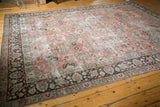 Distressed vintage Tabriz carpet corner with faded floral palmettes in pale raspberry and chocolate.