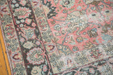 Vintage distressed Tabriz carpet with pale raspberry palmettes and exposed foundation.