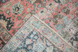 Vintage distressed Tabriz carpet showing exposed foundation, raspberry, and blue floral palmettes.