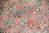 Distressed texture of vintage Tabriz carpet with pale raspberry blush floral palmettes.