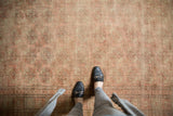 Distressed Bokhara rug's faded rose and ivory elephant footprint guls with low pile.