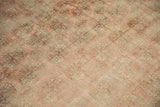 Decorative low pile texture and muted blush guls of the distressed Bokhara carpet.
