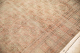 Distressed vintage Bokhara rug featuring textured low pile with faded blush and ivory guls.