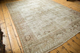 Distressed vintage Mahal rug corner showing exposed foundation and muted floral motifs.