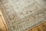 Distressed vintage Mahal carpet corner, showing exposed foundation and subtle patterns.