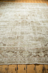 Worn pile and visible foundation on a vintage distressed Mahal carpet end with subtle floral border.
