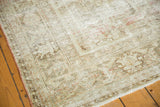 Distressed vintage Mahal carpet with exposed foundation, subtle floral motifs, and muted tones.